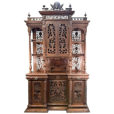 an image of a wooden cabinet with carvings on top of it