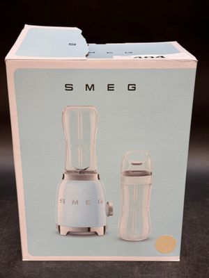 packaging of a blender and a cup sitting on a table
