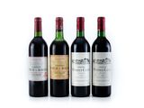 four bottles of wine are lined up on a white surface