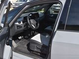 a white car with its door open in a parking lot