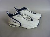 a pair of white and blue shoes on a white surface