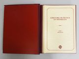an open book with a red cover sitting on top of a white table