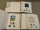 four open books with stamps on them sitting on a table