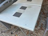 a table and chairs that are outside on the ground