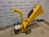 a close up of a small yellow machine on a concrete floor