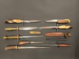 many different types of knives on display on a table