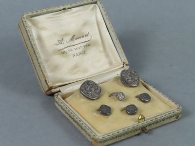 a box with a set of silver cuff watches and cuff rings