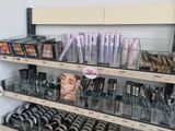 a lot of makeup products on the shelves in the store