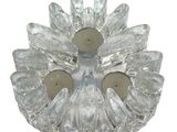 a glass candle holder with two candles inside of it