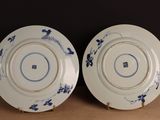 pair of blue and white plates with floral designs on them