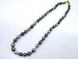 a close up of a necklace on a white surface