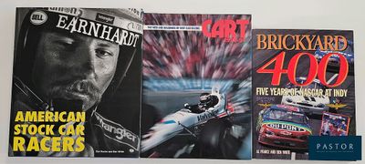 three books of nascar racing on a shelf in a room