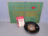 a picture of a casino roulet wheel and a card game