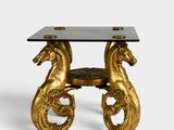 an image of a gold table with two horses on it
