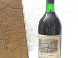 a bottle of wine sitting next to a wooden box