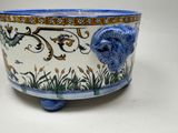 a blue and white bowl with a flower design on it