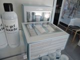 a display case with a lot of bottles of lotion on it