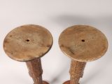 two wooden candlesticks sitting on a white surface