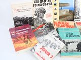 several books on a white table with a white background