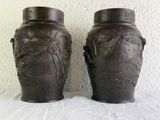 two vases that are sitting on a table