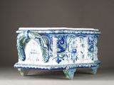a blue and white planter sitting on a table