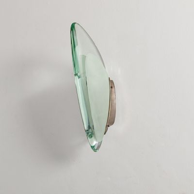 a close up of a green glass object on a white surface