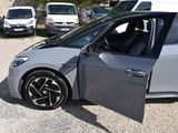 a silver car with its door open in a parking lot