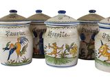 four canisters with animals painted on them sitting next to each other