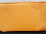 an image of a tan leather bag sitting on a black table