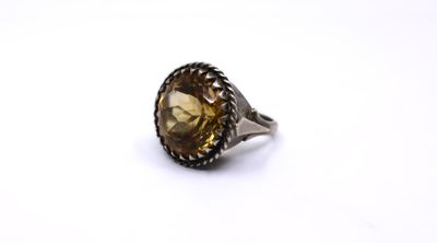 a close up of a ring on a white surface