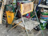 a chair that is sitting next to a stack of buckets