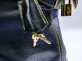 a purse with a key in it and a cell phone in it