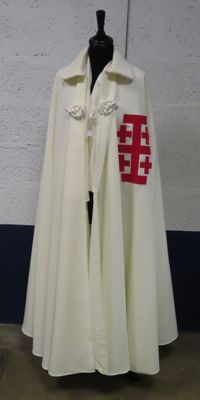a white cape with a red cross on it