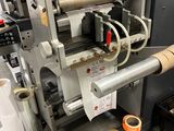 a machine that has a roll of tape on the side of it