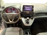 the interior of a small car with a steering wheel and dashboard