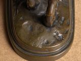 a bronze statue of a horse on a base
