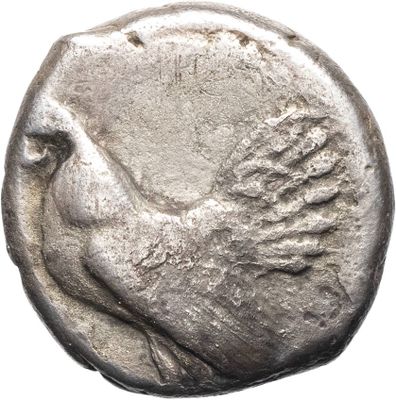 an old silver coin with a bird on it