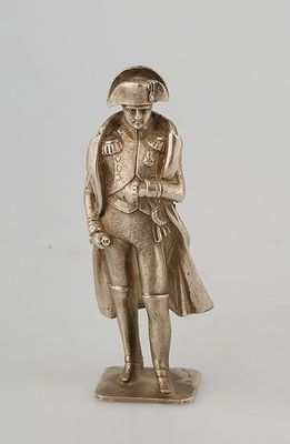 silver figurine of a man with a hat and coat on a base