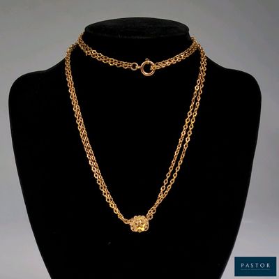 a close up of a gold chain necklace on a mannequin