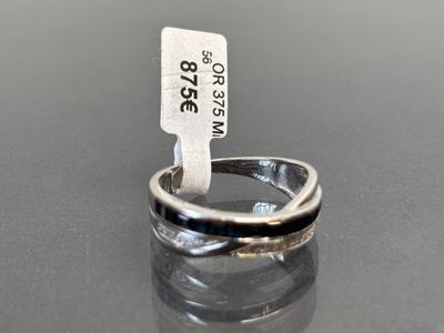 sterling silver ring with a black band and a tag on it