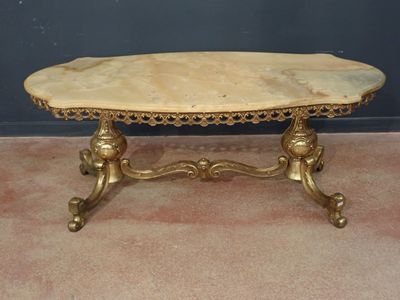 an image of a table with a marble top on a carpeted floor