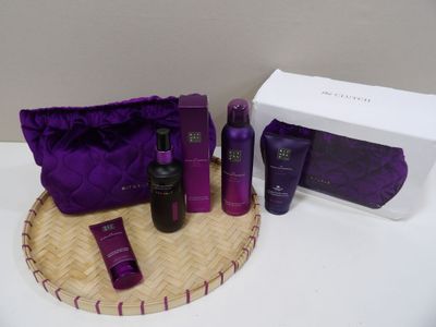 the contents of a purple bag are sitting on a table