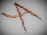 an old pair of scissors with a wooden handle on a gray background