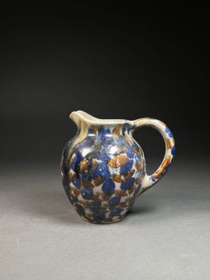 an image of a blue and white pitcher on a table