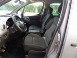 the interior of a small car with black seats and a steering wheel
