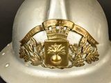 a silver helmet with a gold emblem on it