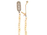 a close up of a pair of earrings with pearls and diamonds