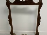 a wooden frame with a mirror on top of it in a room