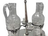 a silver tray with two glass vases and a spoon on it