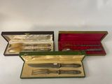 three different types of silverware in a case on a white surface